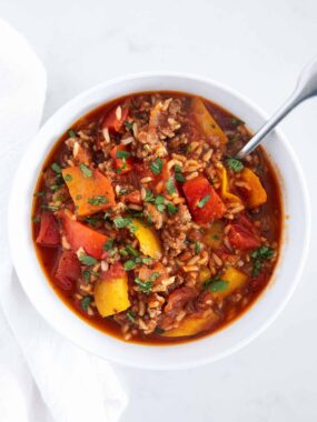 Stuffed pepper soup in a white bowl with spoon.