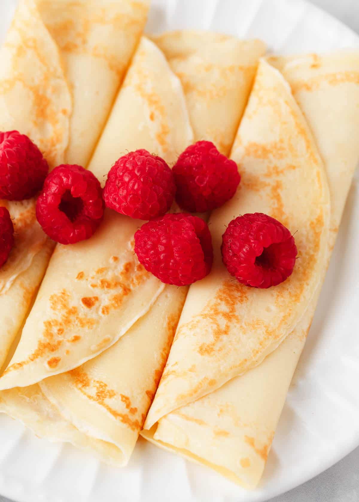 Swedish pancakes on a white plate.