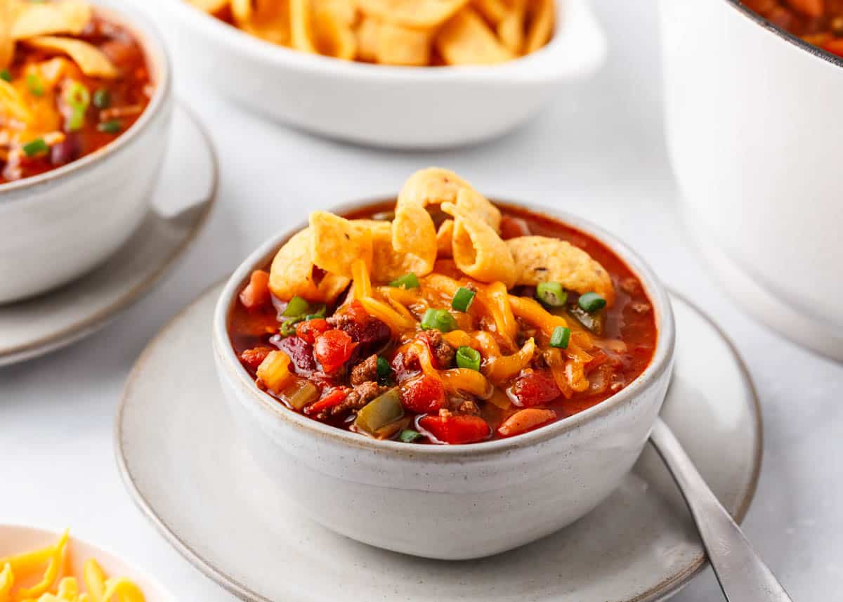 Wendy's chili in a white bowl with cheese on top.