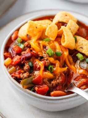 Wendy's chili in a white bowl with spoon.