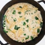 White lasagna soup in a black stockpot.