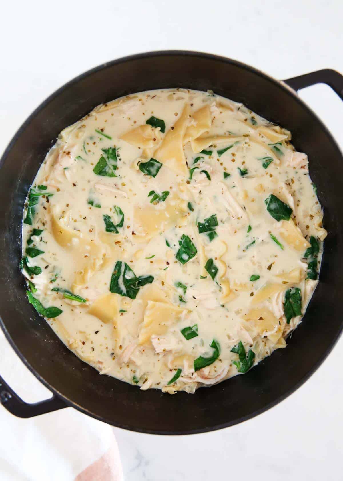 White lasagna soup in a black stockpot.