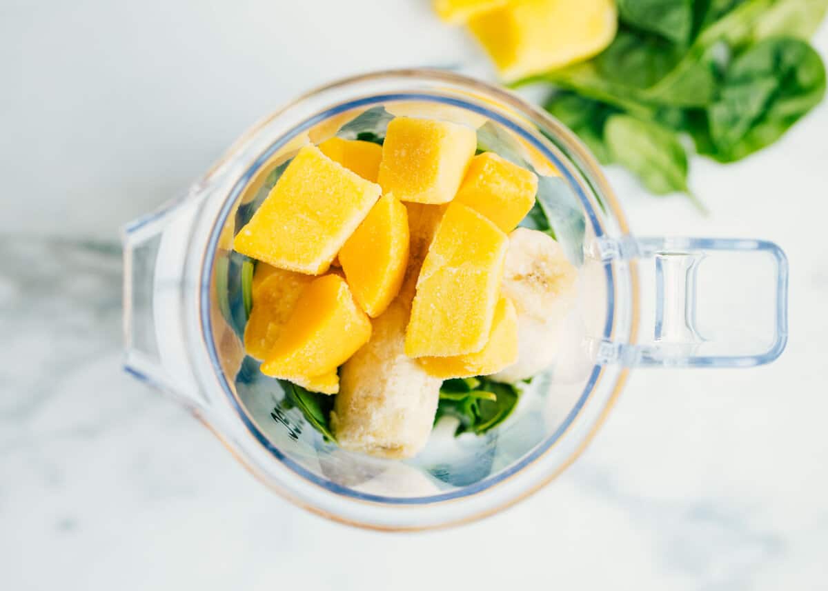 The top of a blender with all the green smoothie ingredients. 