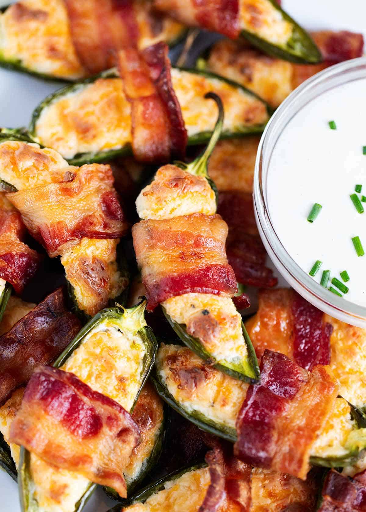 Bacon wrapped jalapeno poppers with a ranch dip on the side. 
