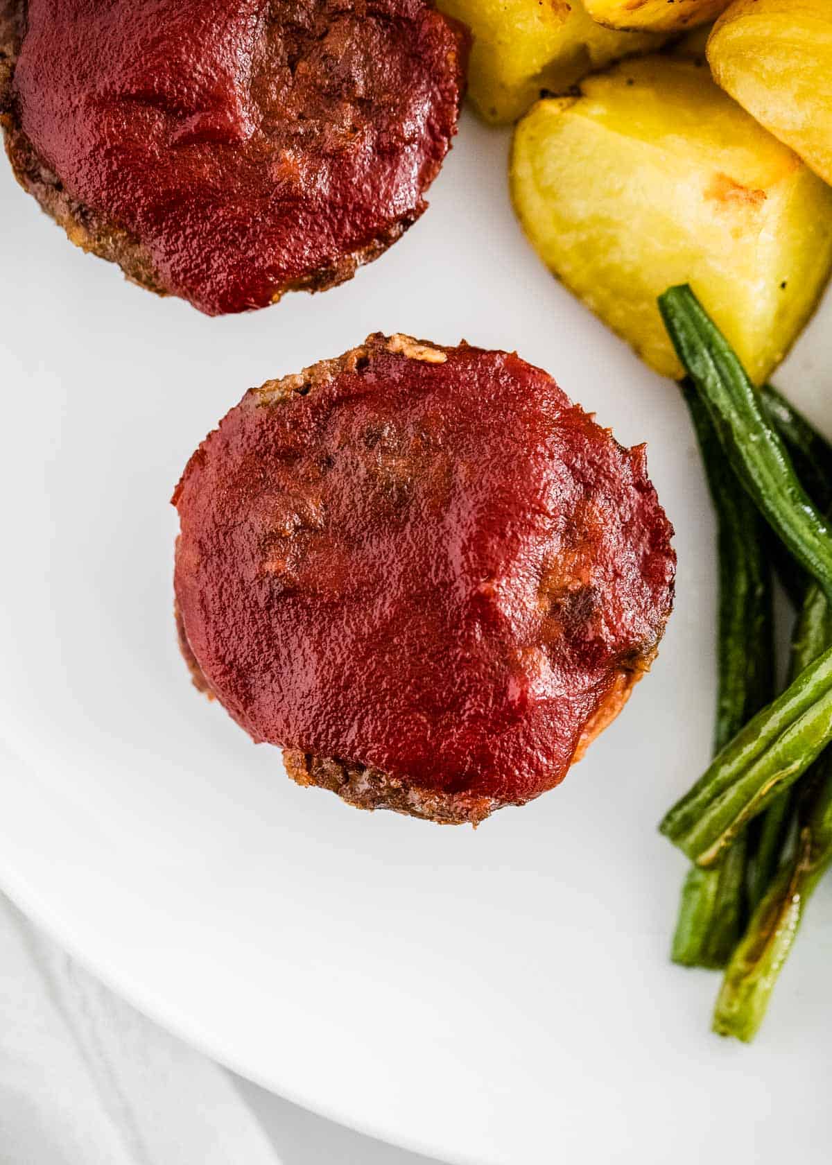 Meatloaf muffins on a white plate.