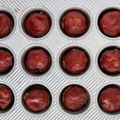 Mini meatloaf muffins baked in a muffin tin and topped with classic meatloaf sauce.