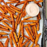 Sweet potato fries on a baking sheet.