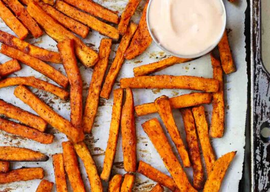 Sweet potato fries on a baking sheet.