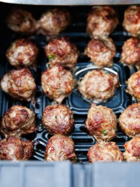 Air fryer meatballs in basket.