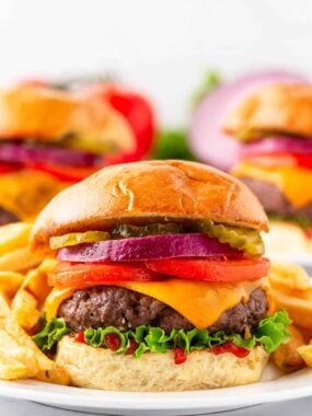 Juicy oven baked hamburger with melted cheese on a bun with classic toppings.