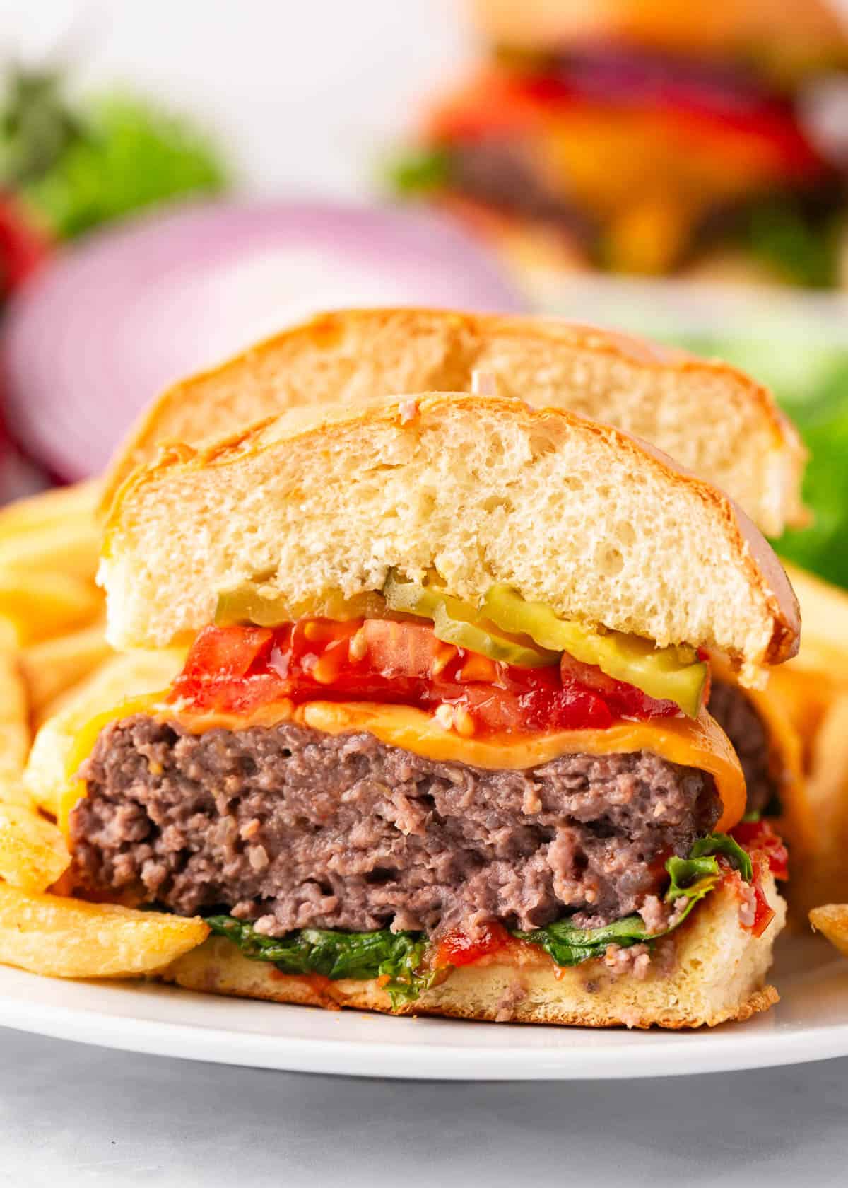 Baked hamburgers sliced in half.