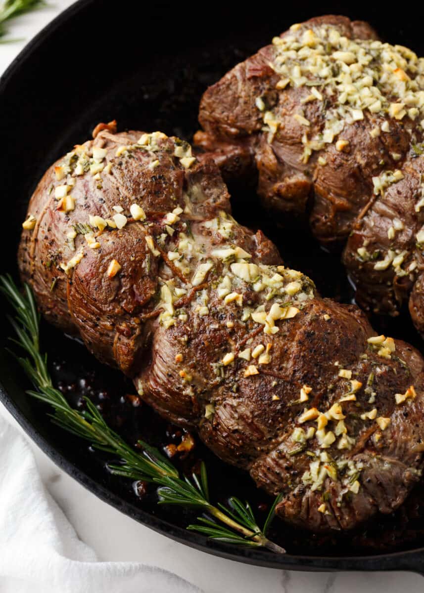 Beef tenderloin cooked in a cast iron skillet.