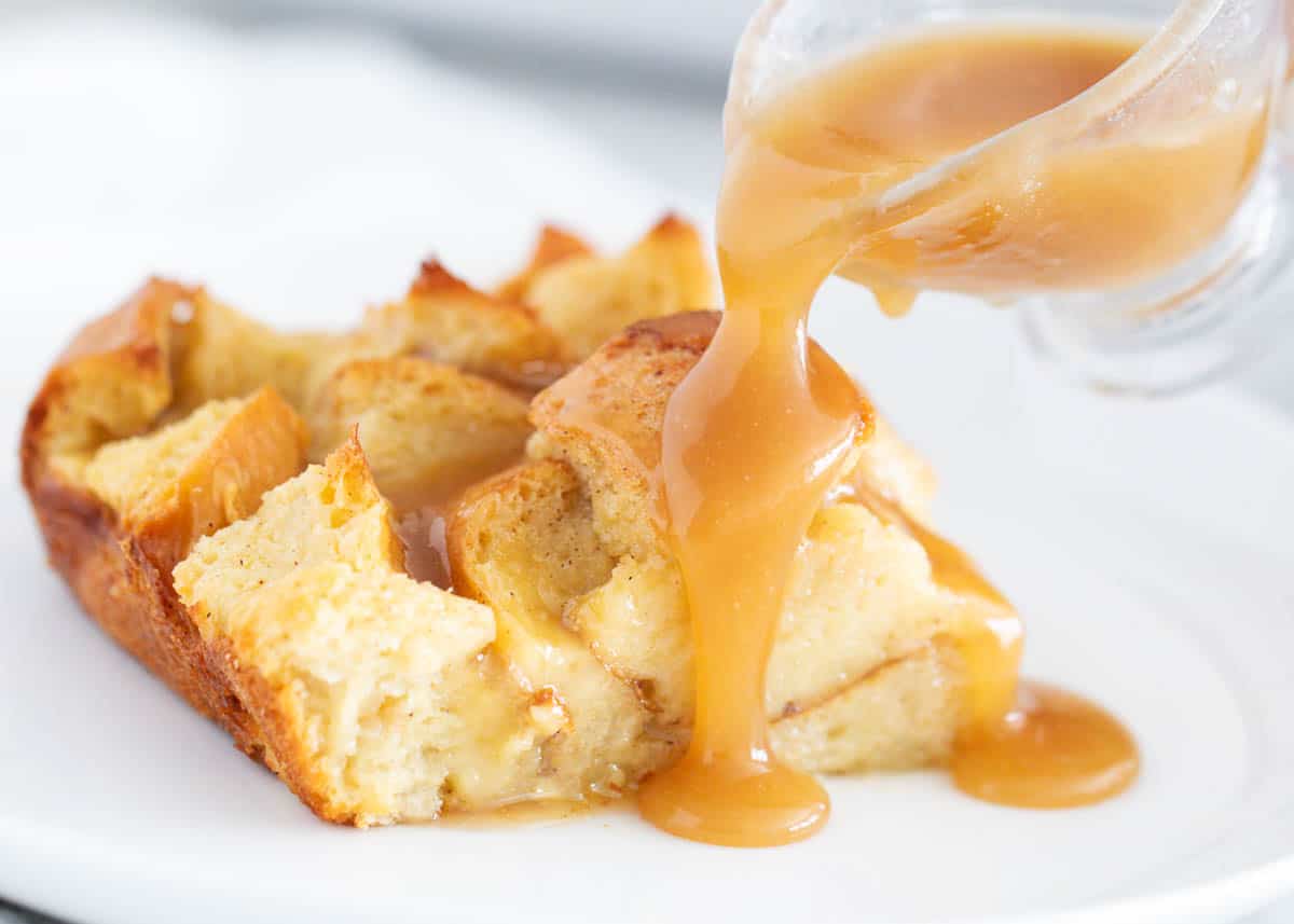 This easy bread pudding sauce is sweet, buttery and filled with caramel and vanilla flavor. Made with only 5 ingredients in just 10 minutes, this sauce is the perfect finishing touch to the classic holiday dessert! Bread pudding with sauce pouring over top.
