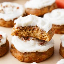 Stacked carrot cake cookies with frosting.