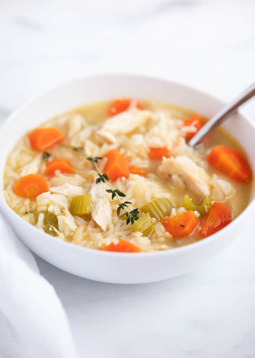 Chicken and rice soup in a white bowl.