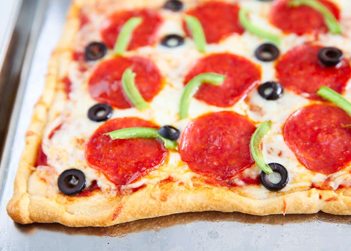 Crescent roll pizza on baking sheet.