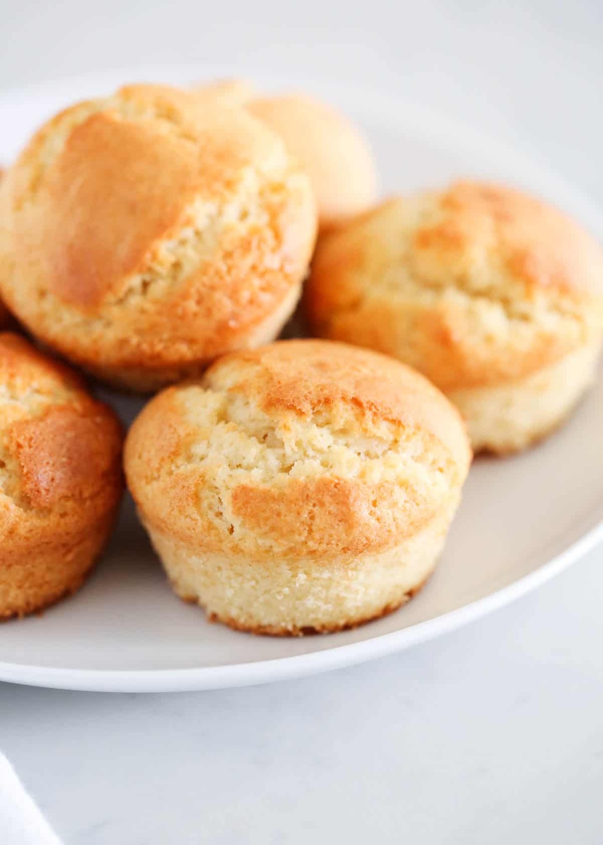 Breakfast muffins on a white plate.