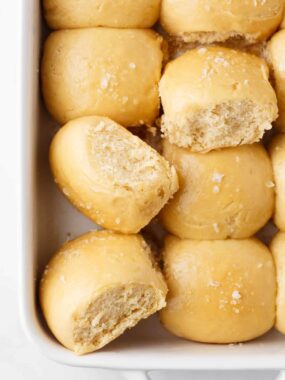 Hawaiian rolls in a white baking dish.