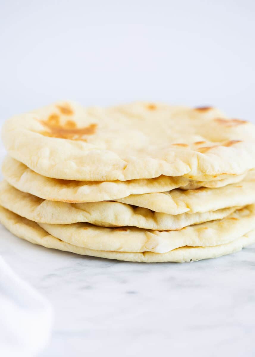 Stacked pita bread on the counter.