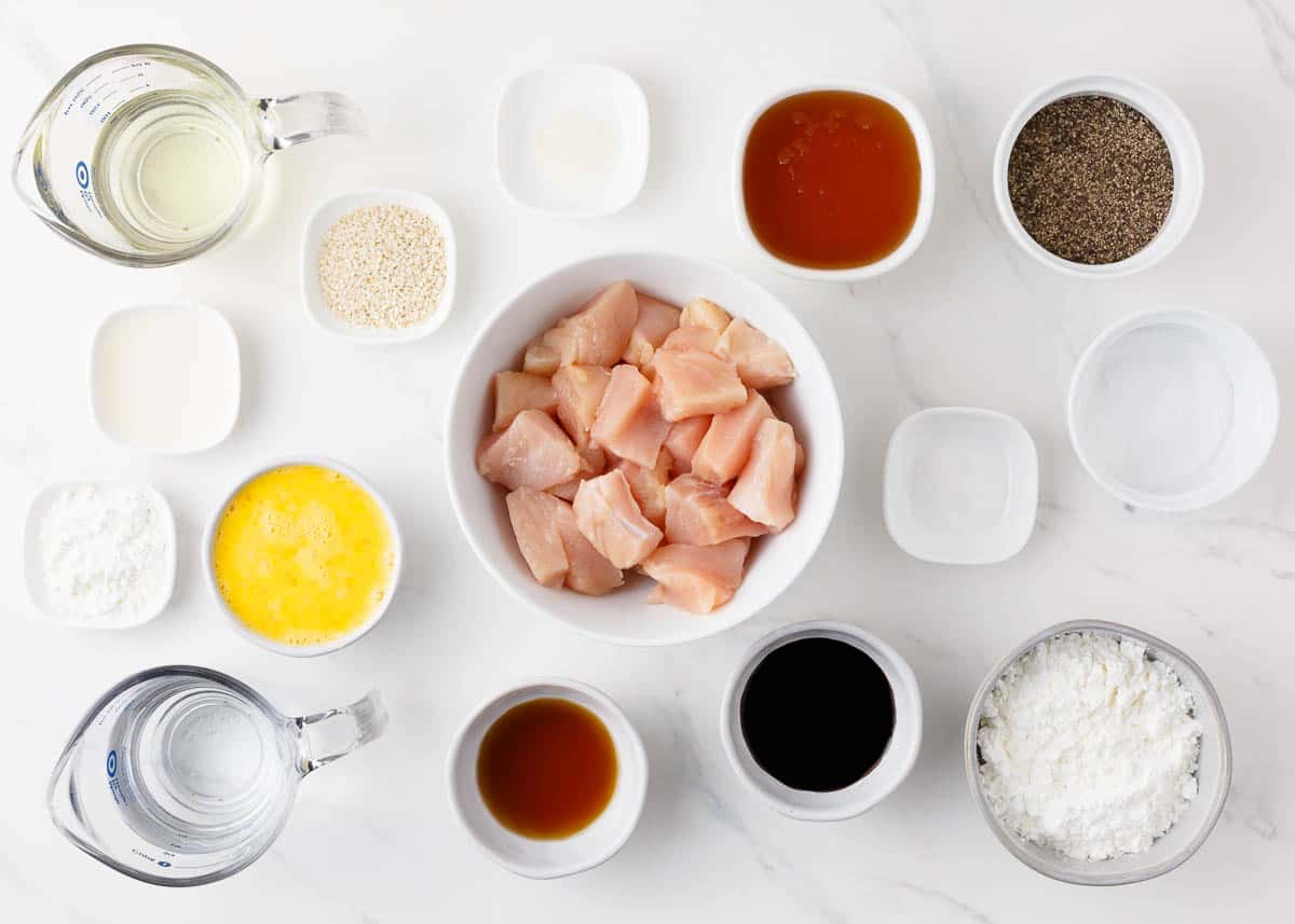 Honey sesame chicken ingredients on a marble counter. 