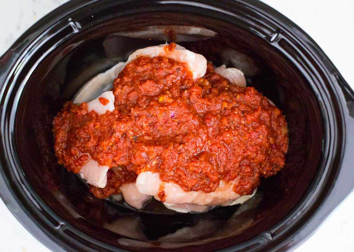 Showing how to make chicken tinga in a crockpot.