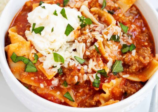 Lasagna soup in a white bowl.