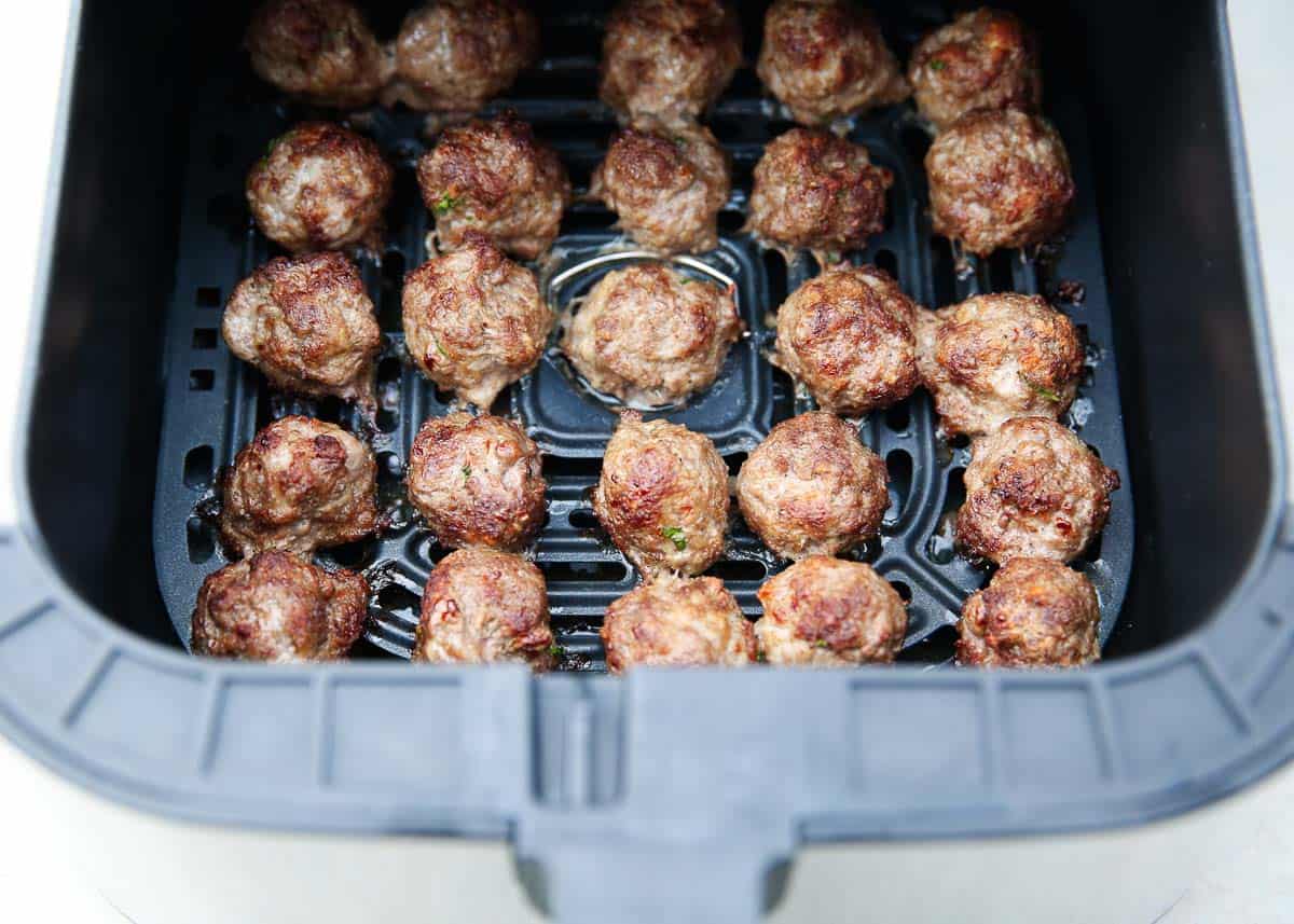 Tender and juicy air fryer meatballs are easy to make in just minutes. Enjoy a batch of these delicious homemade meatballs for a weeknight meal with pasta, in a sub or as an appetizer! Air fryer meatballs in the air fryer basket.