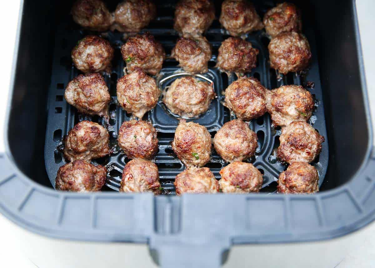 Air fryer meatballs in the air fryer basket.