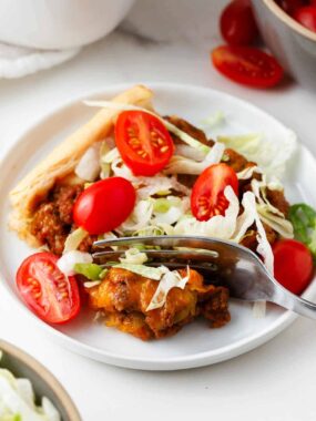 Taco bake slice on a white plate.