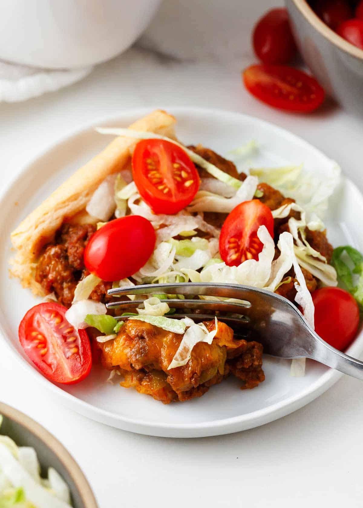 Taco bake slice on a white plate.