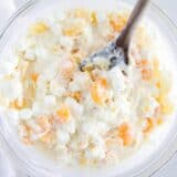 Ambrosia salad in a glass bowl.