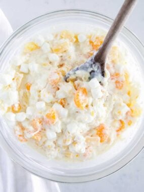 Ambrosia salad in a glass bowl.