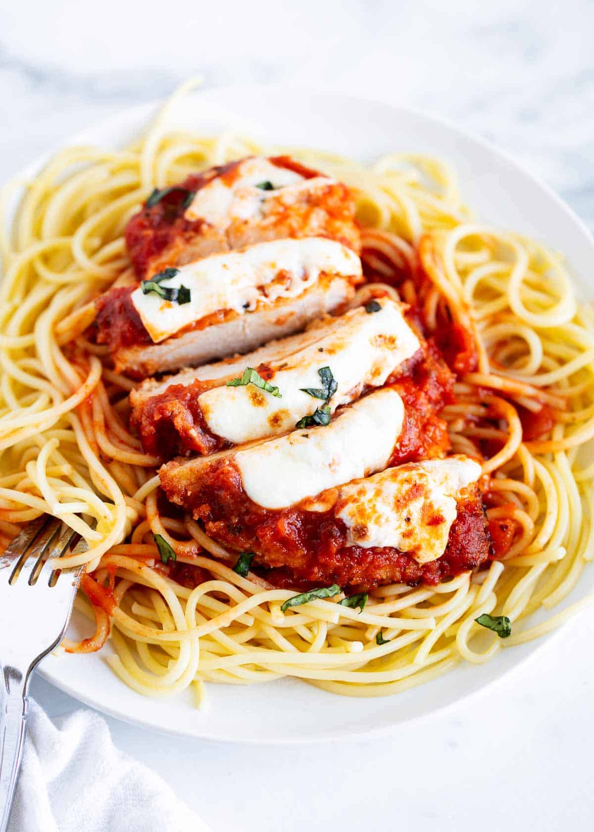 Chicken parmesan over top of noodles. 
