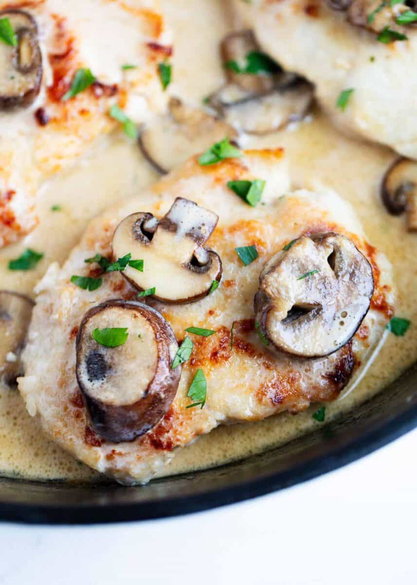 Chicken marsala cooked in a skillet.