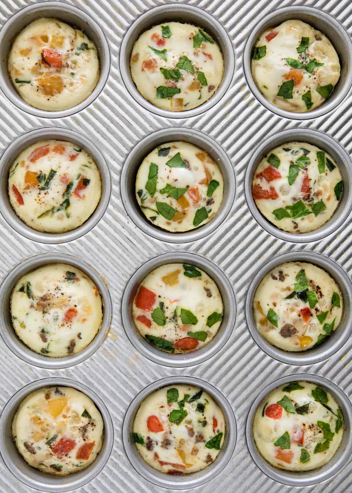Egg white muffins in a muffin tin.
