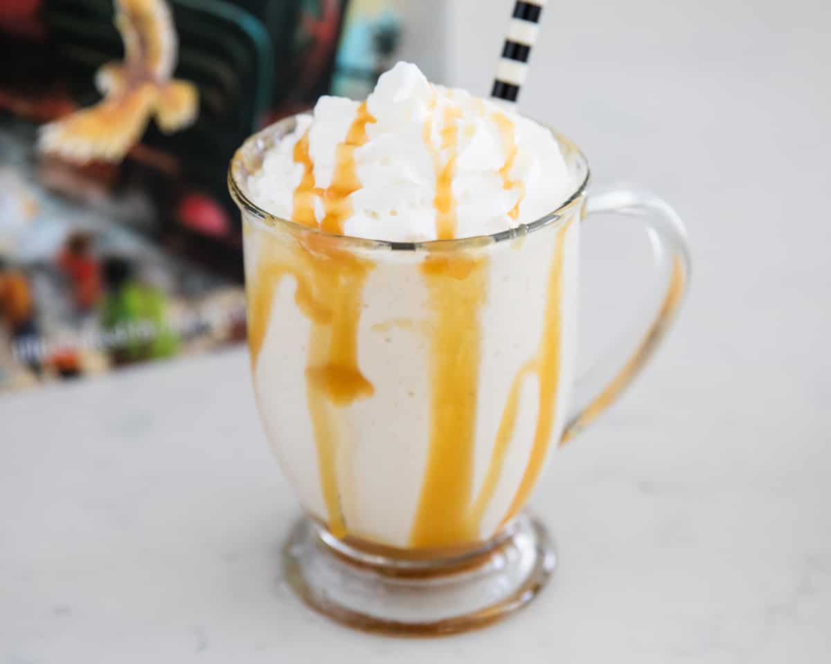 Butterbeer in a mug with straw. 