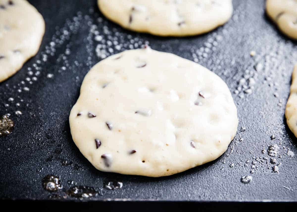 Cooking a chocolate chip pancake on the griddle.