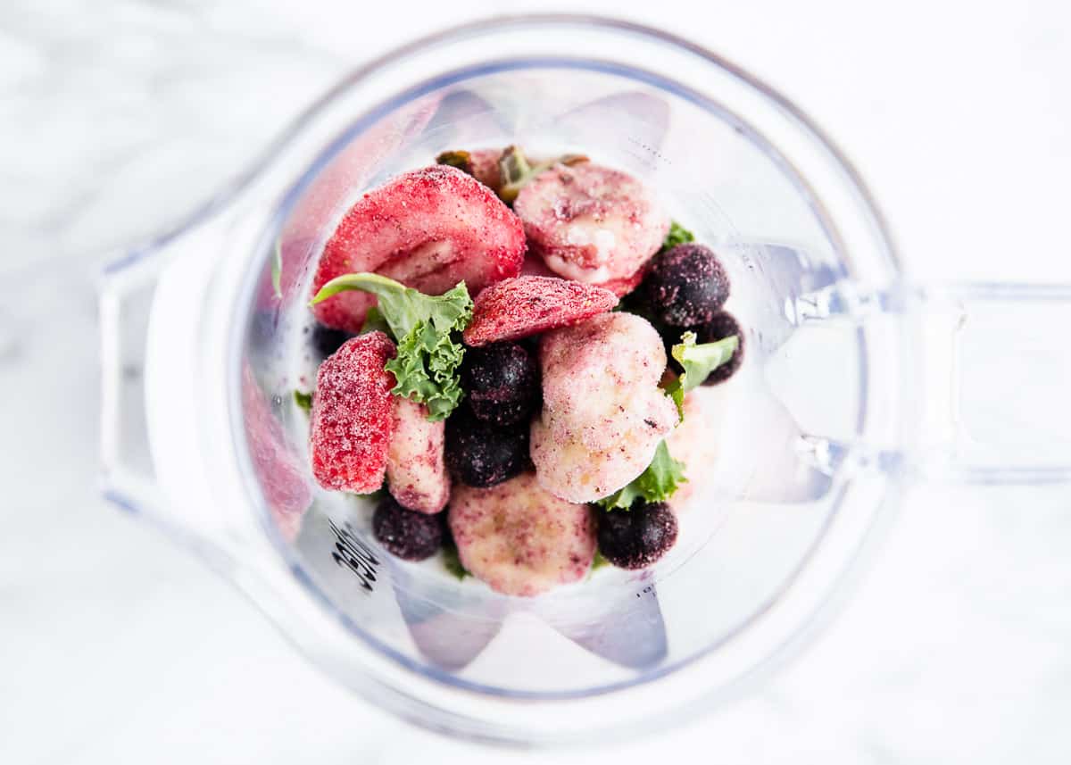 Showing how to make kale smoothie in a blender.