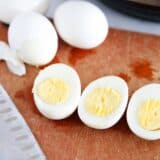 Cut eggs on cutting board.