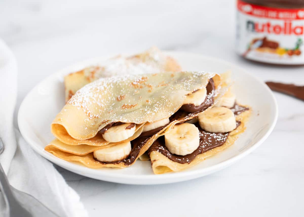 Nutella crepes on a white plate. 