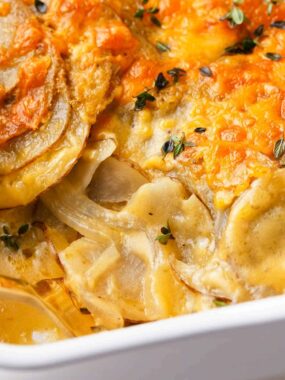 Potatoes au gratin in a white baking dish.