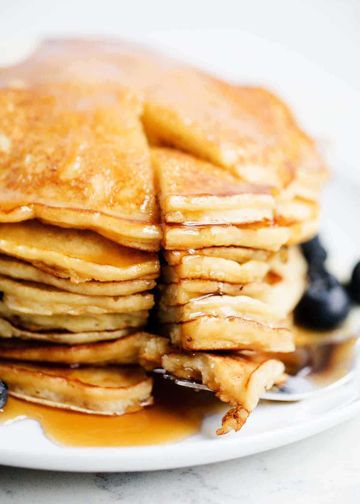 Stack of ricotta pancakes on a plate.