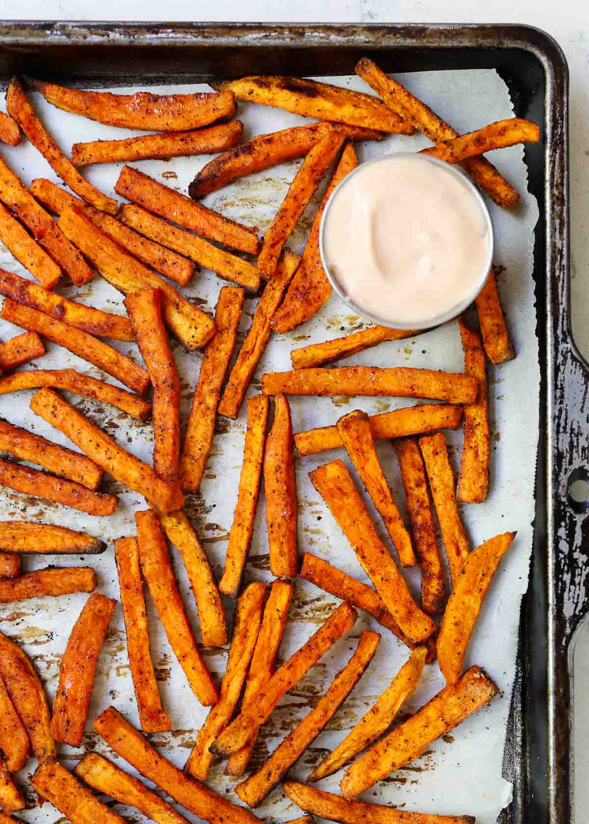 Sweet potato fries on a baking sheet.