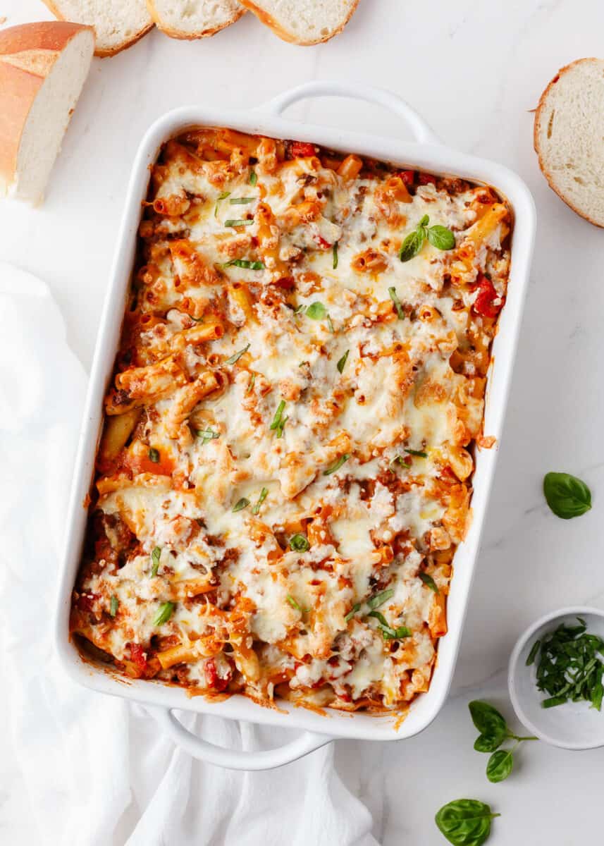 Baked ziti in a white baking dish.