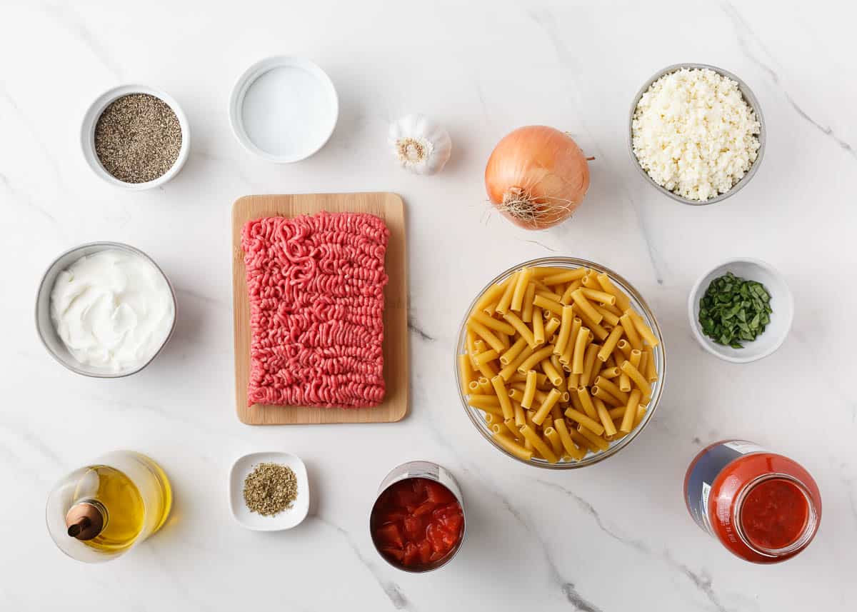 Ziti ingredients on marble counter.