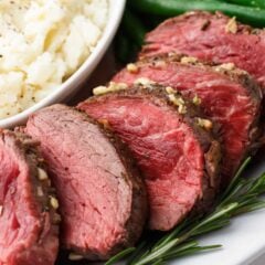 Close up of sliced beef tenderloin recipe on plate showing tender, juicy results.