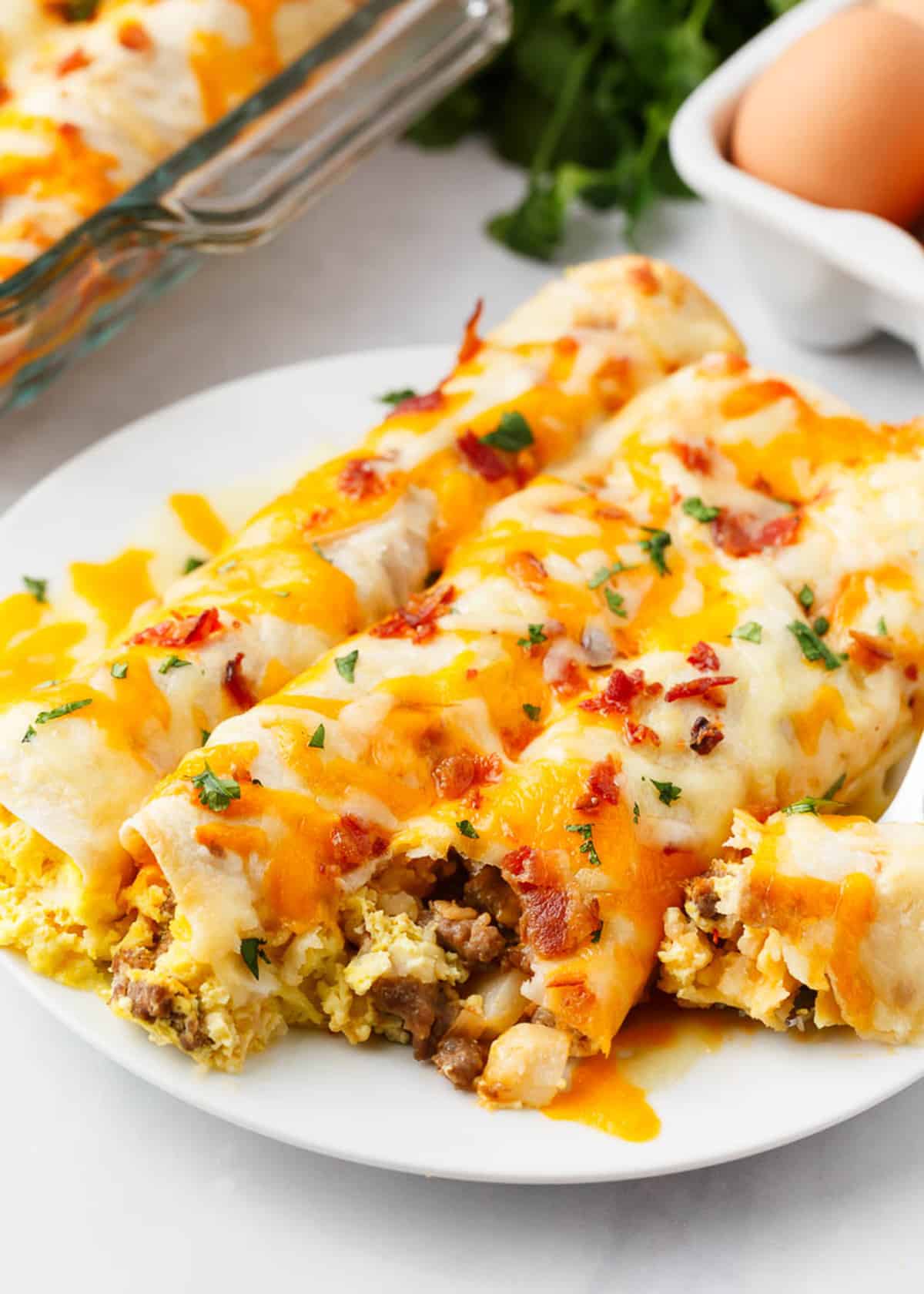 Breakfast enchiladas on a white plate.