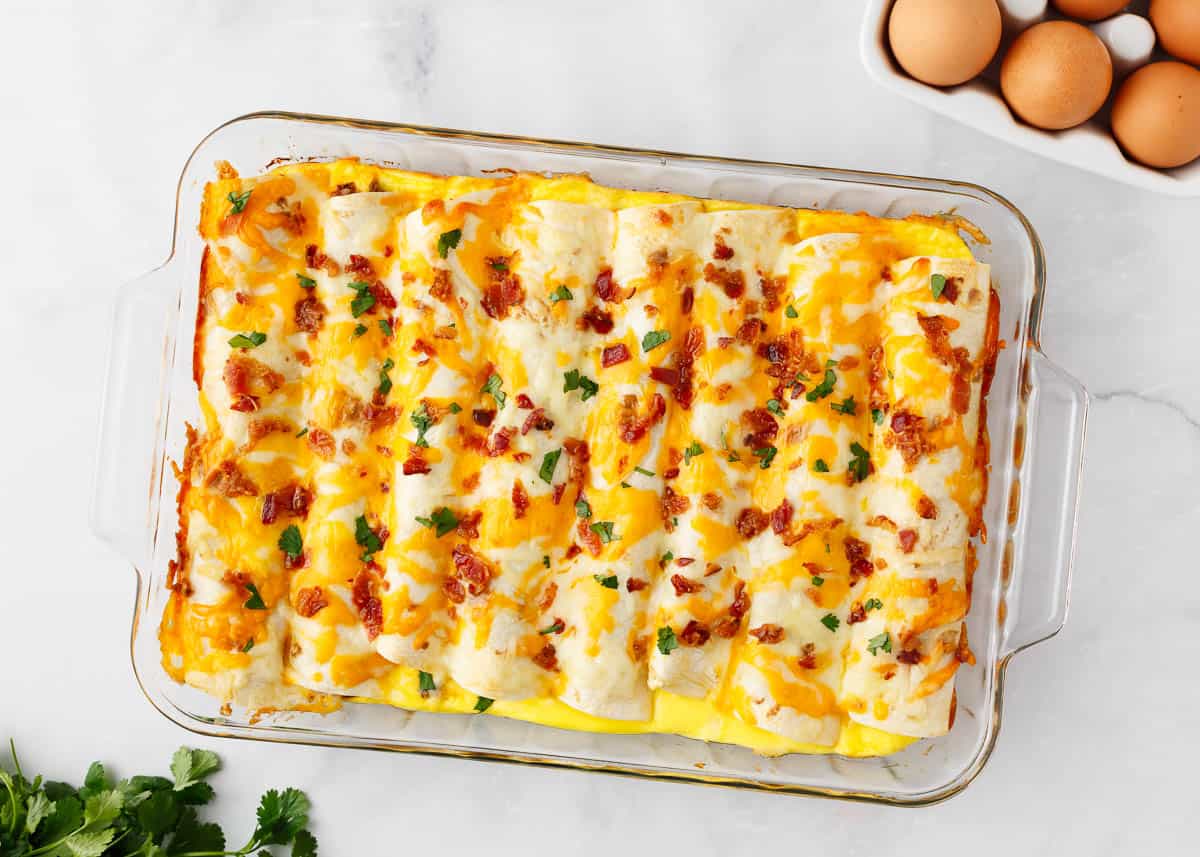 Breakfast enchiladas in a glass baking dish.