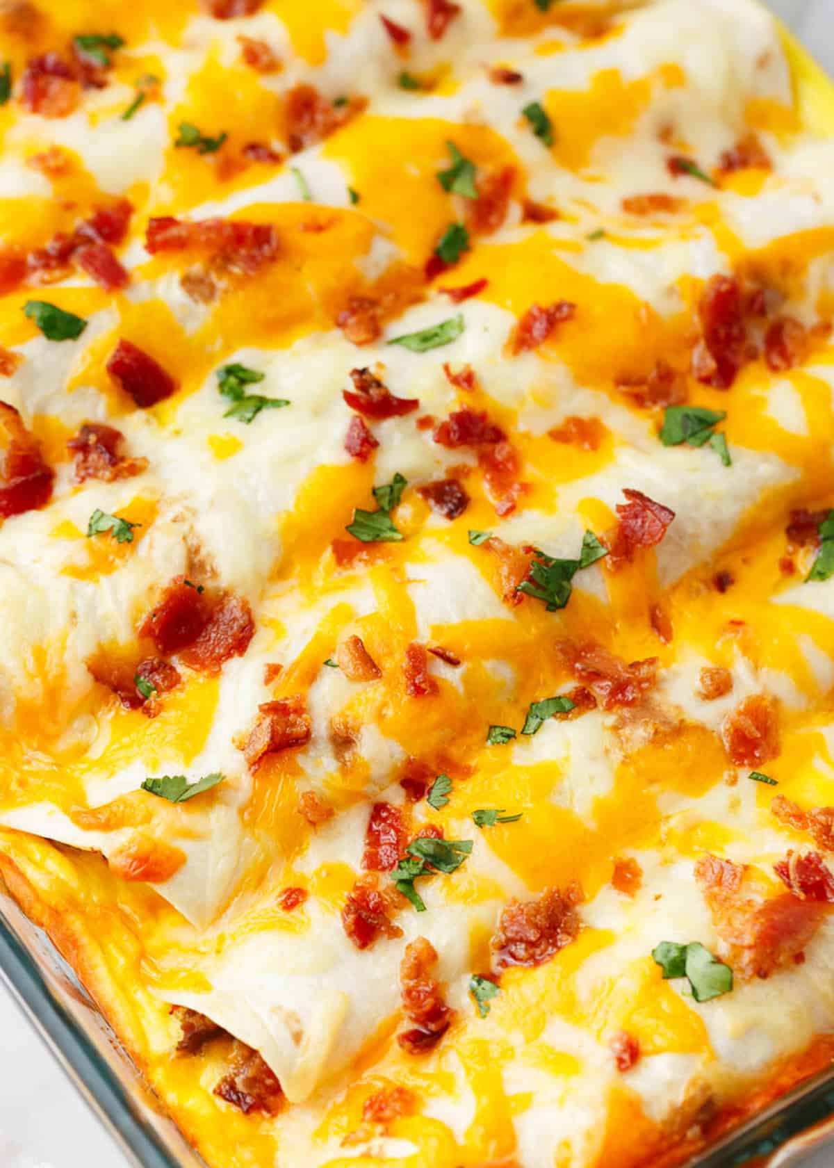 Breakfast enchiladas in a glass baking dish.