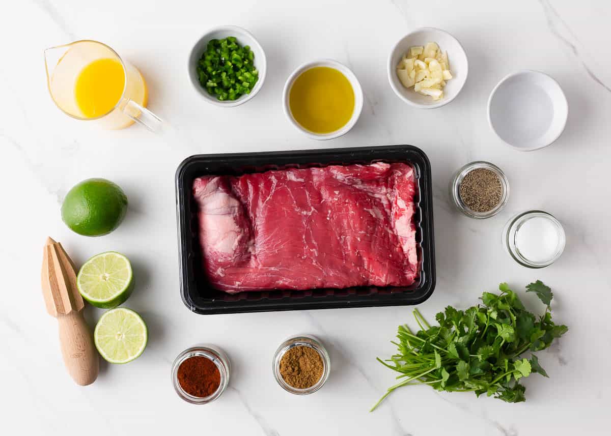 Carne asada ingredients on marble counter.